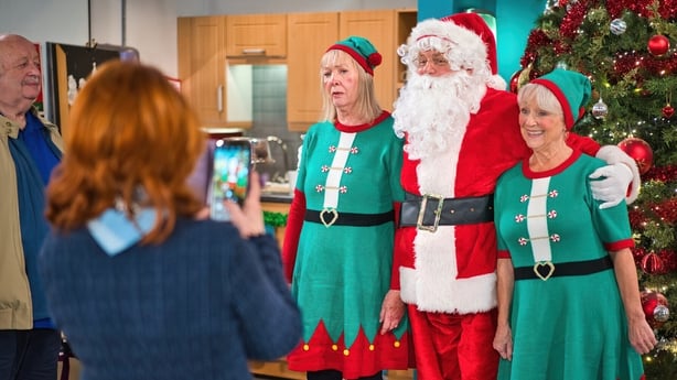 Pete (Enda Oates) poses for a photo with elves Jacinta (Deirdre Donnelly, left) and Nora (Ruth Hegarty)
