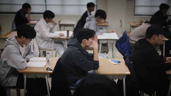 Students wait for the start of the annual college entrance exam, known locally as Suneung, at an exam hall in Seoulon