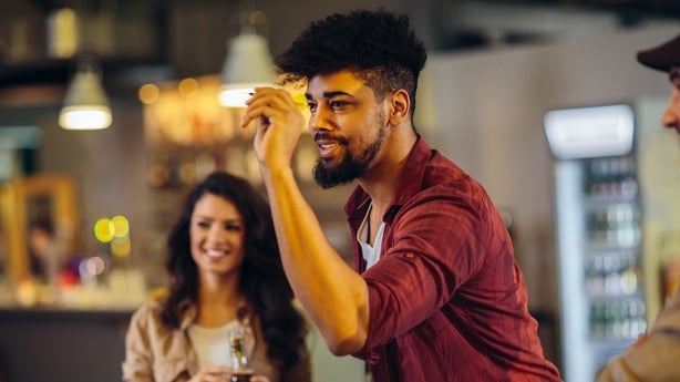 Cropped shot of friends playing darts