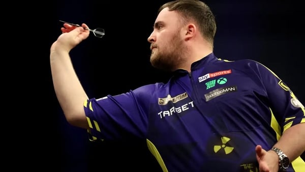 Luke Littler playing darts