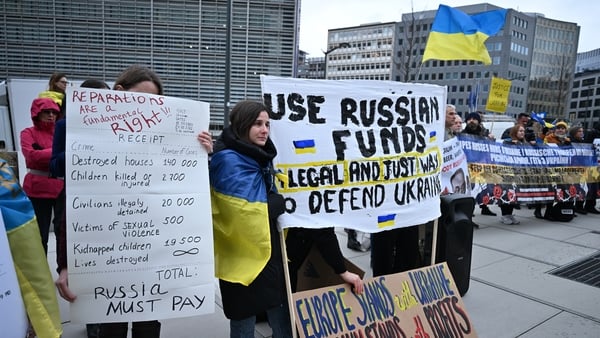 Protesters, carrying Ukrainian flags and banners, gathered in front of the EU Council building