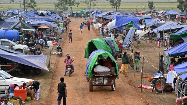 Displaced people arrive at a temporary camp of tents in Cambodia's Oddar Meanchey province.