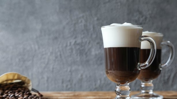 Two Irish coffees with coffee beans on the table
