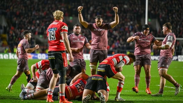 13 December 2025; Tadhg Beirne of Munster, hidden, scores his side's fifth try, as teammate Tom Ahern, centre, celebrates during the Investec Champions Cup match between Munster and Gloucester at SuperValu Páirc Ui Chaoimh in Cork. Photo by Brendan Moran/