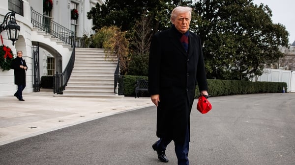 US President Donald Trump walks to speak to members of the media on the South Lawn of the White House before boarding Marine One in Washington
