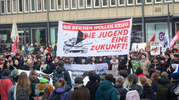 A group of protestors demonstrate outside the Dom Cathedral against voluntary conscription.
