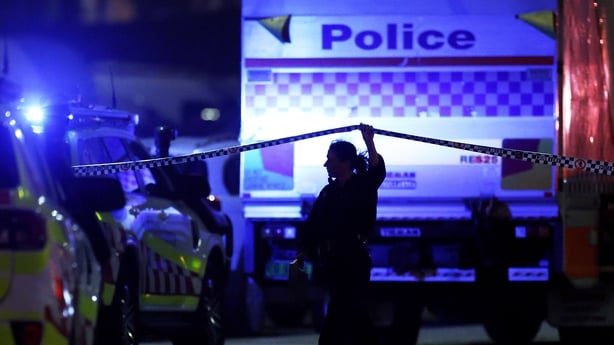 A police officer walks along cordon tapeline at the scene of a mass shooting at Bondi Beach on December 14, 2025 in Sydney, Australia