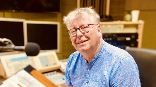 writer Sean O'Gorman, studio for Sunday Miscellany, sitting behind mic and turned sideways to camera, Dec 2025