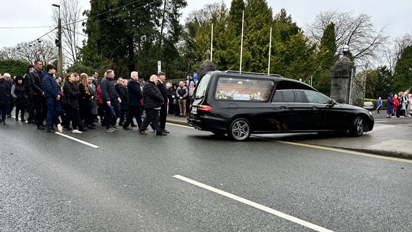 Mourners follow the hearse at Mary Holt's funeral