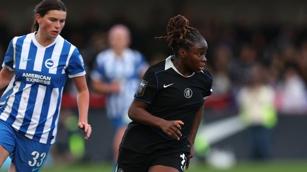 CRAWLEY, ENGLAND - DECEMBER 14: Sandy Baltimore of Chelsea is put under pressure by Charlize Rule of Brighton & Hove Albion during the Barclays Women's Super League match between Brighton & Hove Albion and Chelsea FC at Broadfield Stadium on December 14, 2025 in Crawley, England. (Photo by Steve Bar