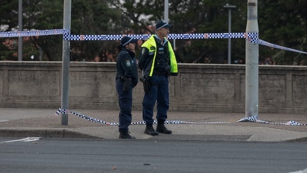 Police officers stand guard at a cordoned zone following the mass shooting at Bondi Beach in Sydney, Australia