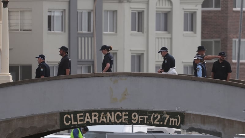 Police on the pedestrian bridge at the scene of the shootings at Bondi Beach