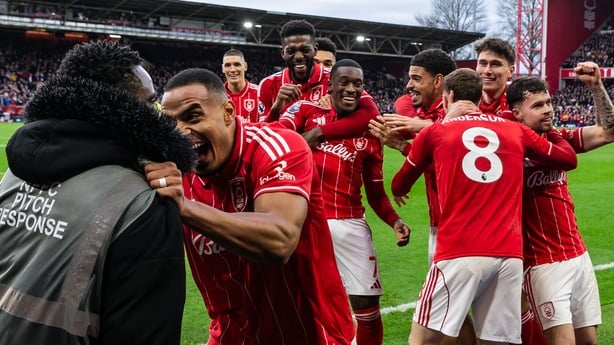 NOTTINGHAM, ENGLAND - DECEMBER 14: Nottingham Forest's Murillo celebrates with a member of the pitch response team after Callum Hudson-Odoi scored his side's second goal during the Premier League match between Nottingham Forest and Tottenham Hotspur at City Ground on December 14, 2025 in Nottingham,