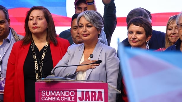 Jeannette Jara stands behind a podium during a speech to her supporters after the presidential election.