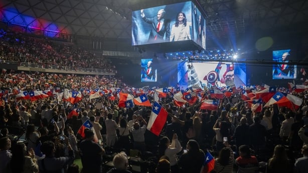 Jose Kast walks on stage during a closing campaign rally at Movistar Arena in Santiago.