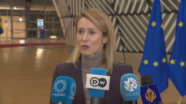 Kaja Kallas speaks to reporters in Brussels with EU flags in the background