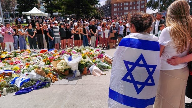 Members of the public gather at a memorial outside the Bondi Pavilion at Bondi Beach 