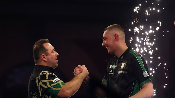 LONDON, ENGLAND - DECEMBER 15: Brendan Dolan of Northern Ireland is congratulated by Tavis Dudeney of England after victory during day five of the 2025/26 Paddy Power World Darts Championship at Alexandra Palace on December 15, 2025 in London, England. (P