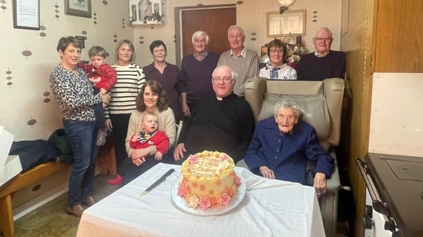 Nell Hynes and some of her family with a big birthday cake