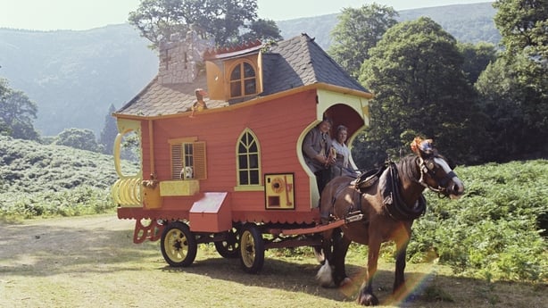 The caravan used in RTÉ Television's young people's programme 'Wanderly Wagon', in Powerscourt, County Wicklow, in August 1977. Eugene Lambert as O'Brien and Nora O'Mahony as Godmother are in the front seat. 