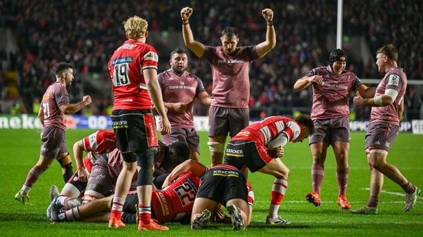 Cork , Ireland - 13 December 2025; Tadhg Beirne of Munster, hidden, scores his side's fifth try, as teammate Tom Ahern, centre, celebrates during the Investec Champions Cup match between Munster and Gloucester at SuperValu Páirc Ui Chaoimh in Cork. (Photo By Brendan Moran/Sportsfile via Getty Images