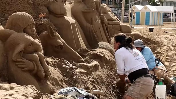 Sculptures work on a nativity sand sculpture in Spain