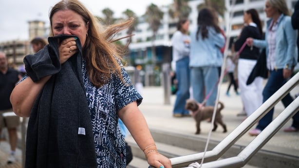 The mother of 10-year-old shooting victim, Matilda Valentina, stands outside of a memorial at Bondi Pavilion at Bondi Beach 