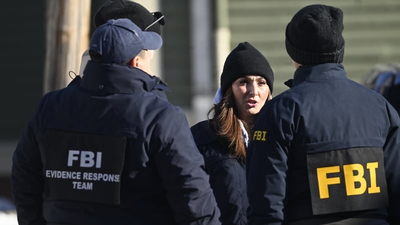 Members of the FBI Evidence Response Team work at the scene outside in Providence