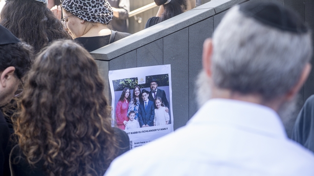 Mourners gather outside the funeral service of Rabbi Eli Schlanger