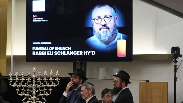 Mourners gather at a synagogue for the funeral of Rabbi Eli Schlanger,