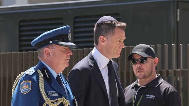 New South Wales Premier Chris Minns (C) arrives for the funeral of rabbi Eli Schlanger