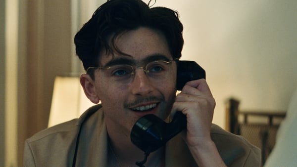 Timothée Chalamet talking on the phone in Marty Supreme