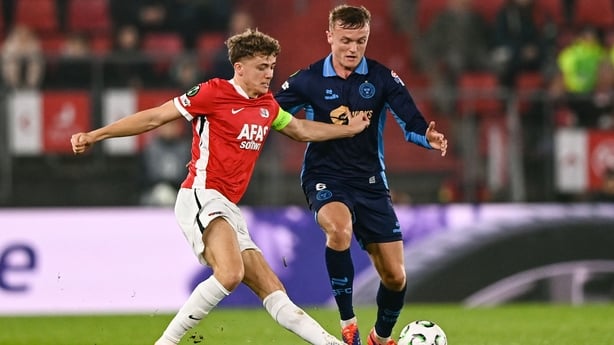 27 November 2025; JJ Lunney of Shelbourne in action against Sven Mijnans of AZ Alkmaar during the UEFA Conference League 2025/26 league phase match between AZ Alkmaar and Shelbourne at AFAS Stadion in Alkmaar, Netherlands. Photo by Ben McShane/Sportsfile