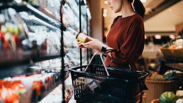  woman in shop reading food label