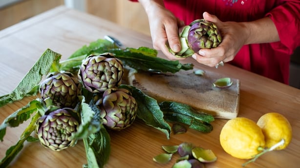 Woman preparing artichokes