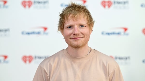 Ed Sheeran smiles for a photo