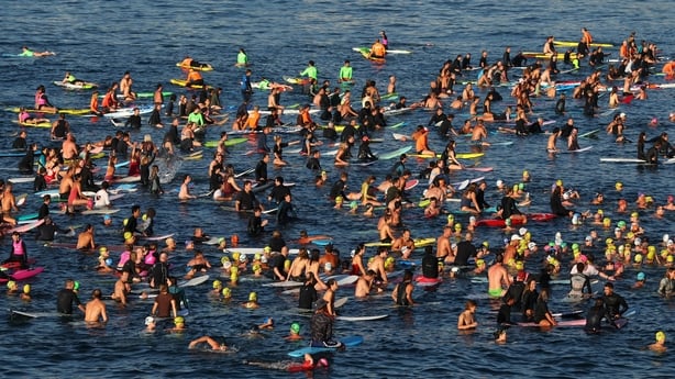 Members of the Bondi community pay their respects during a Paddle Out to honour victims