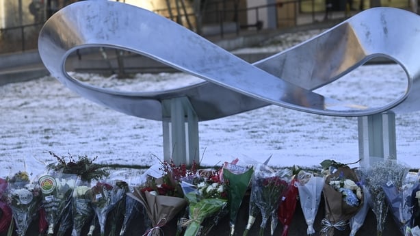 A view of the flowers as mourners gather at a memorial outside of the Brown University Engineering Research Center