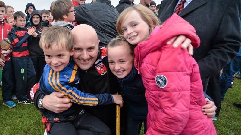 Family ties: Fergal Hartley celebrates back in 2014 with his children, including current Ballygunner senior hurler Mark (L)