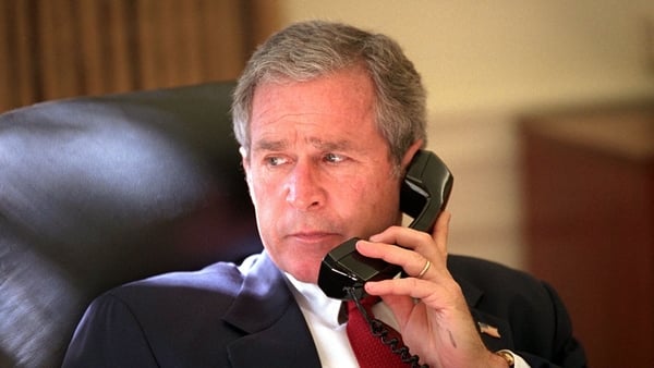 President George W. Bush speaking to Canada's Prime Minister Jean Chretien, one of several world leaders he spoke to before telling the nation of air strikes against the Taliban regime in Afghanistan. (Photo by Eric Draper/Greg Mathieson/Mai/Getty Images