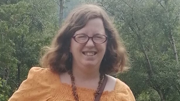 A photo of Maud Coffey standing in front of trees