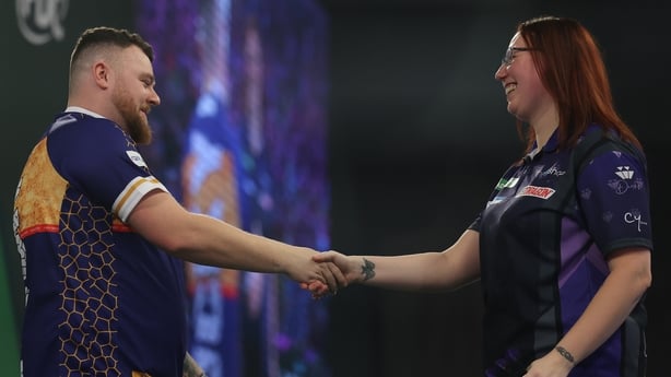 Josh Rock of Northern Ireland and Gemma Hayter of England shake hands at the end of their match on Day Nine of the 2025/26 Paddy Power World Darts Championship at Alexandra Palace on December 19, 2025 in London, England
