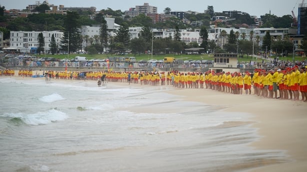 Hundreds of surf rescuers participate in a Shoulder2Shoulder memorial event for victims of the terrorist attack at Bondi Beach 