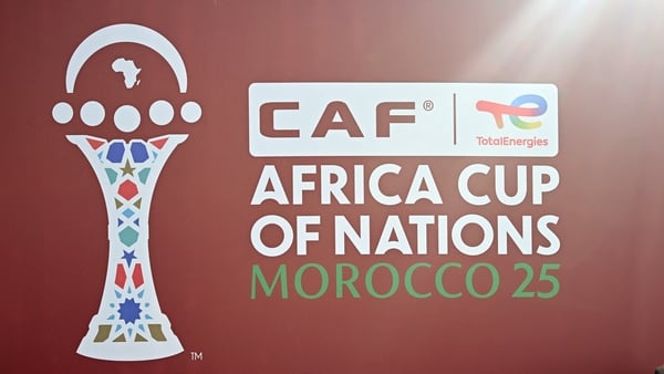 Tools and supplies for workers used to make the final touches to the outside of the Al-Medina Stadium in Rabat, are left near the game's logo on December 18, 2025, ahead of the Africa Cup of Nations (AFCON). The competition begins on December 21. (Photo b