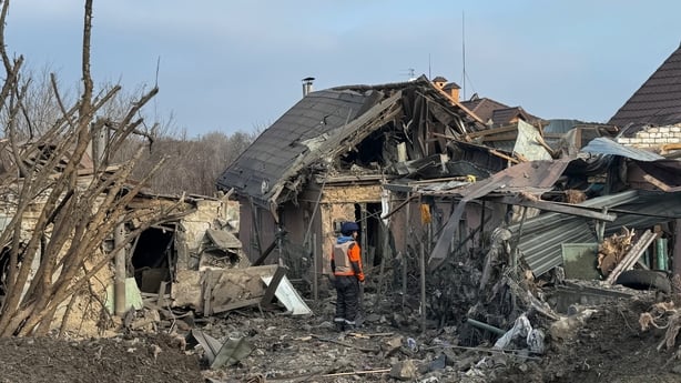 A rescuer stands amid rubble in the yard of house after Russian shelling in Zaporizhzhia, Ukraine
