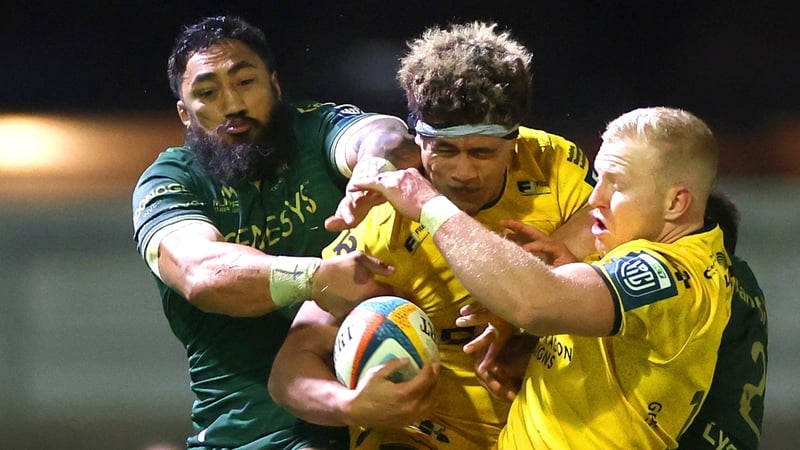 Bundee Aki competes for a high ball against Fine Inisi and Tinus de Beer of Dragons