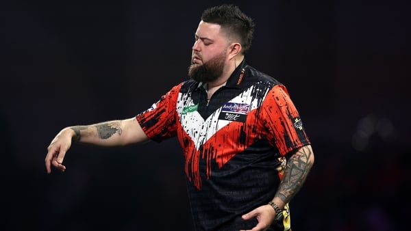 Michael Smith of England looks dejected after defeat to Niels Zonneveld of the Netherlands (not pictured) during the Round Two match between Michael Smith and Niels Zonneveld in the 2025/26 Paddy Power World Darts Championship at Alexandra Palace on Decem