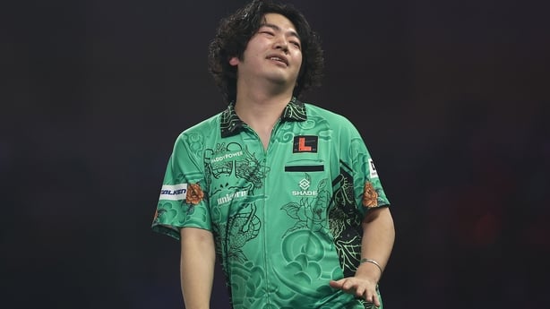 Motomu Sakai of Japan reacts against Andreas Harrysson of Sweden during their Round 2 match in the Paddy Power World Darts Championship at Alexandra Palace on December 20, 2025 in London, England
