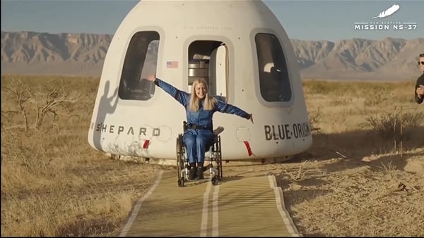 Photo show Michaela Benthaus in front of space capsule