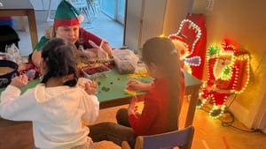 Santa makes an early stop to bring gifts to homeless children show image